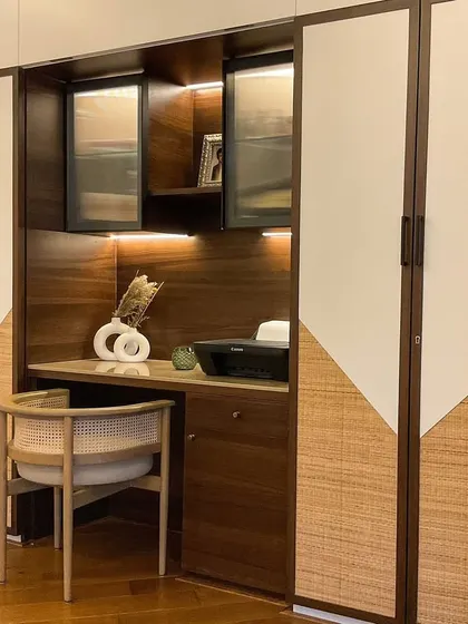 A before-and-after of a study desk transformation. We turned a simple wall into a beautiful and functional workspace with custom cabinetry and lighting.