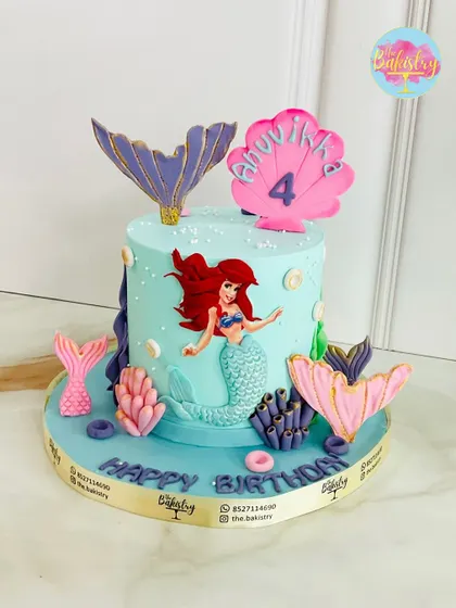 A magical mermaid cake for Anuvikha's 4th birthday, featuring Ariel, colorful coral, and shimmering mermaid tails.
