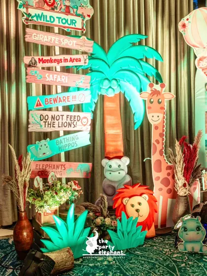 I created this fun, directional signpost for the safari party, with signs pointing to the 'Giraffe Spot', 'Bathing Hippos', and 'Wild Tour', adding to the immersive jungle experience.