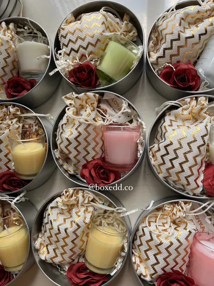 An overhead view of our return gift tins, showing the variety of candle colors we can include. This allows you to match the favors to your event's color palette.