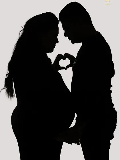 This is a duplicate of image 17. We use creative lighting in our studio to craft these artistic and romantic silhouette portraits that focus on the baby bump and the connection between partners.