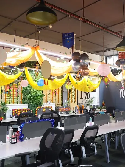 Another view of the decorated office space, showing how drapes and balloons can completely change the look and feel of a regular work environment.