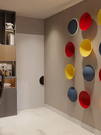 A beautifully designed work-from-home office space. This area features colorful wall art and a clean, organized bookshelf, blending productivity with creative inspiration.