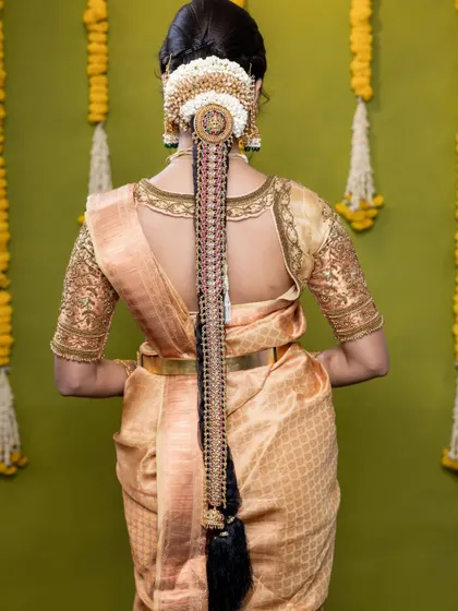 The back view shows the beautiful hair accessory that completes this elegant bridal style.
