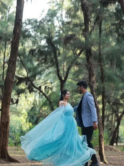 The flowing fabric of our sky-blue gown looks beautiful in this woodland pre-wedding shoot.