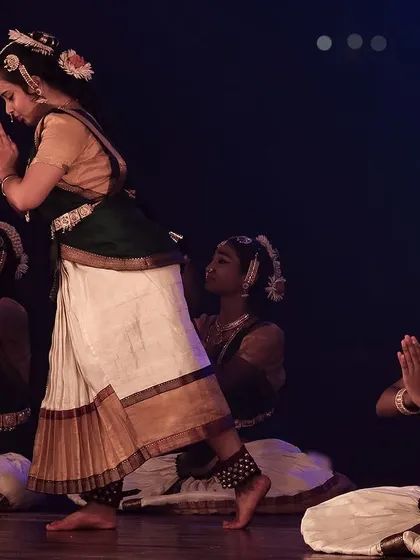A moment of prayer and reverence within the dance.
