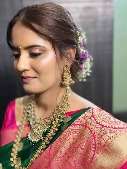 My stunning bride, ready for her engagement. This Maharashtrian look features soft, glowing makeup that complements her beautiful green and pink silk saree.