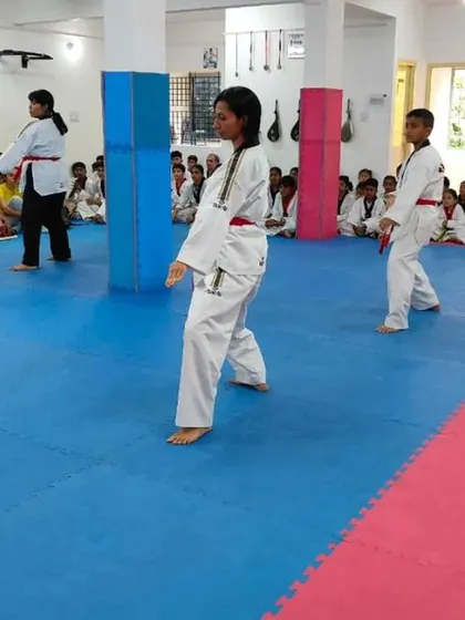 A student practices her form during the belt exam.