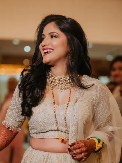 A candid shot of my reception bride Sejal, laughing and enjoying her celebration. Her soft glam makeup and ivory lehenga create a look of pure joy and elegance.
