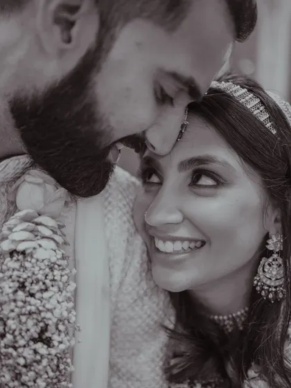 A black and white shot that captures the deep emotion between the couple. Her smile and the way she looks at him say it all.