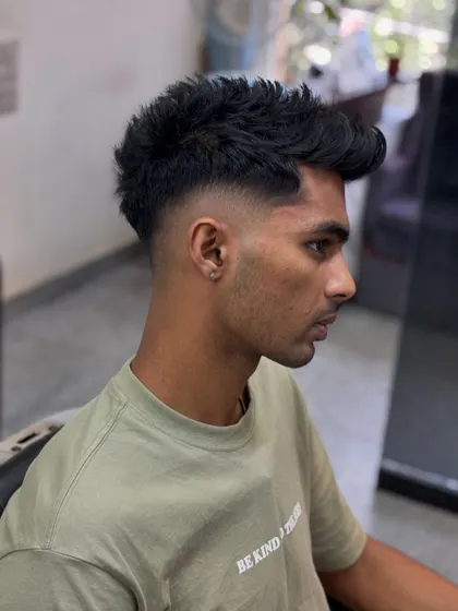 A side profile of a textured crop with a high skin fade. This is a very popular men's hairstyle that is both stylish and low-maintenance.