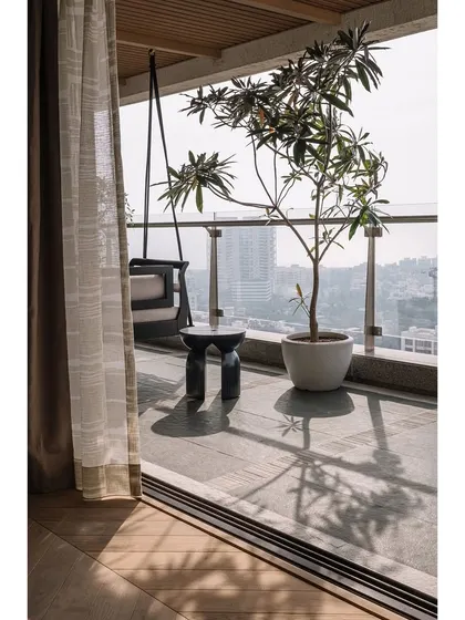 The view from the master bedroom onto the deck, where a potted Champa tree casts beautiful shadows throughout the day.