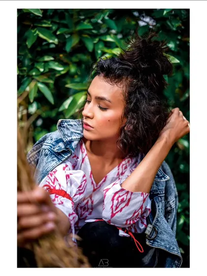 A close-up, intimate portrait from the same series. The soft light and her pensive expression create a quiet and beautiful moment.