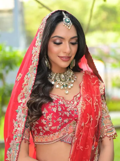 Draped in dreams. A beautiful shot of my bride in her red lehenga, with soft waves, smoky eyes, and perfectly draped dupatta.