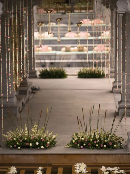 The aisle is the first step into your new life together. We lined these grand venue steps with floral arrangements and traditional brass lamps, creating a beautiful and welcoming path for the couple and their guests.