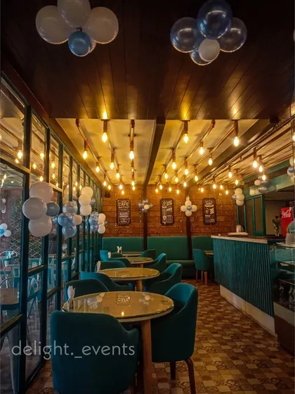 We can add simple, festive touches to enhance a venue's existing ambiance. For this cafe, we added small clusters of balloons throughout the space to complement the industrial-chic lighting and decor for a private party.