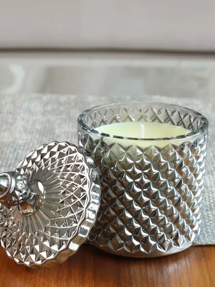 The shimmer of our silver Crystal Cove candle. The cut-glass jar catches the light beautifully, making it a stunning decorative piece for any modern or classic interior.