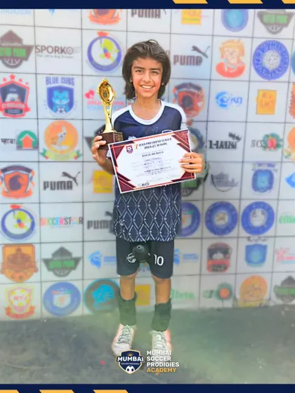 A player receives his trophy after a strong 2-1 victory for the U11s.