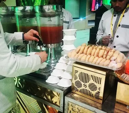 A guest enjoying freshly prepared pani puri from our live station, complete with three different water options.