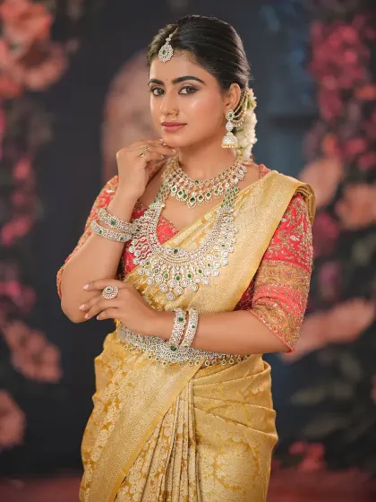 This bride is adorned with layered diamond jewelry, and the makeup is designed to complement it without being overpowering. The look is regal and sophisticated.