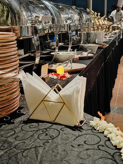A view from behind our buffet line, showing a chef at work. Our professional team ensures everything runs smoothly from start to finish.