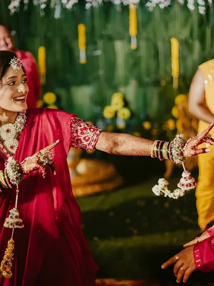 The bride and groom share a dance during their Haldi ceremony.