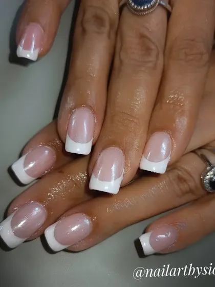 A classic French manicure with a twist. This set has a pearlescent finish, giving the timeless design an updated, shimmery look.