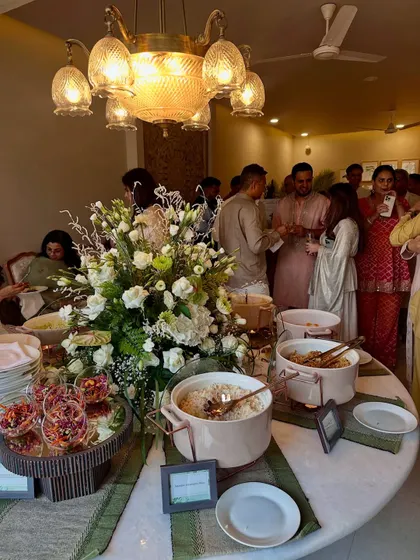 Guests mingling and enjoying the food at our buffet station, which is designed to be both beautiful and functional.
