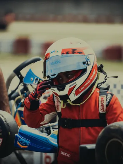 A close up of a young driver, focused and ready.