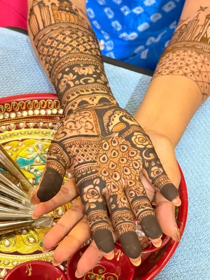 A close-up of the palm, showing the intricate details of the peacock and floral patterns.