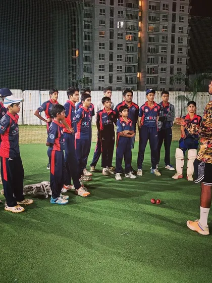 A coach delivering a motivational talk to the team under the lights. We teach the importance of mindset, strategy, and playing as a cohesive unit.