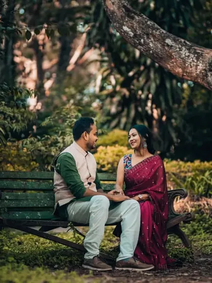 A couple shares a quiet conversation on a park bench, a simple yet powerful image of their connection from a pre-wedding session.