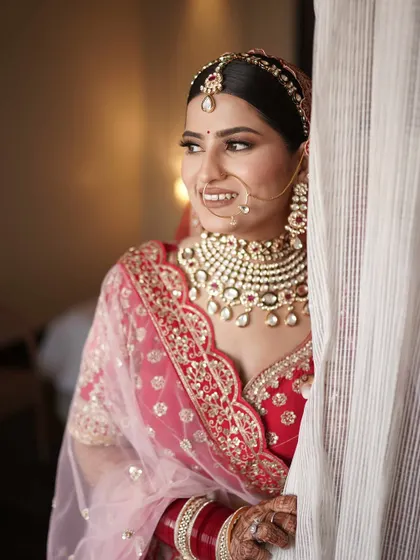 A candid peek of the bride. Her soft smile and glowing makeup create a timeless and beautiful bridal portrait.