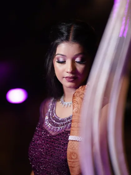 From natural to glamorous, we create the perfect look that complements your style. This shimmery purple eye makeup is a fantastic choice for a sangeet or cocktail party.