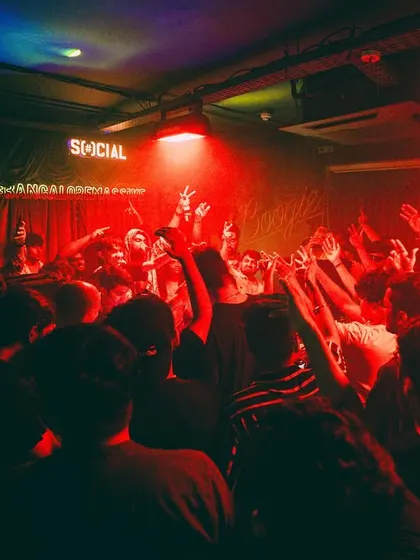 The red lights and raised hands say it all. A snapshot of the intense energy during a Drum and Bass night in Bangalore.