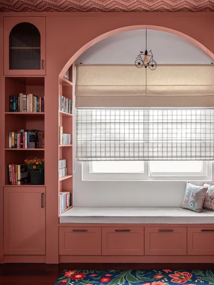 A closer look at the custom bay window seating, showing the built-in storage drawers underneath and the cozy cushions, making it a perfect reading nook.