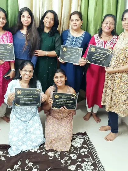 All smiles at the end of our saree draping workshop as students receive their certificates.