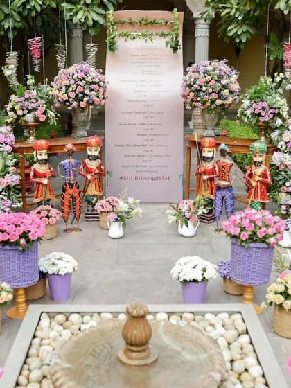 The welcome area, featuring a personalized itinerary, traditional Rajasthani puppets, and an abundance of fresh flowers.
