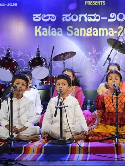 A wide shot of our junior Carnatic vocal group, all dressed in traditional attire for their big day.