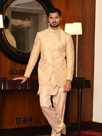 A more formal pose in the same golden ethnic jacket, showcasing its versatility for different types of shots.