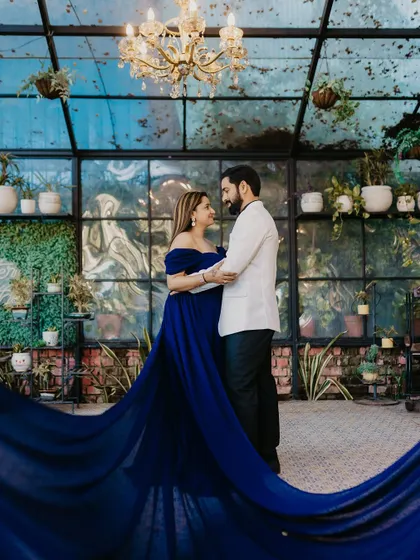 A stunning shot inside a glasshouse, with the flowing gown creating beautiful lines and movement.