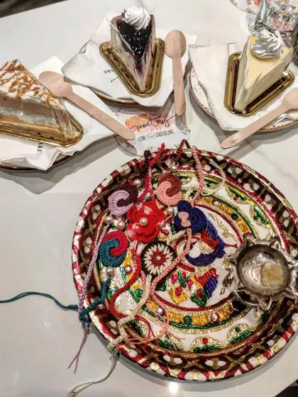 A festive Rakshabandhan thali filled with our diverse collection of handmade crochet rakhis. This image captures the celebratory spirit and variety of our designs.