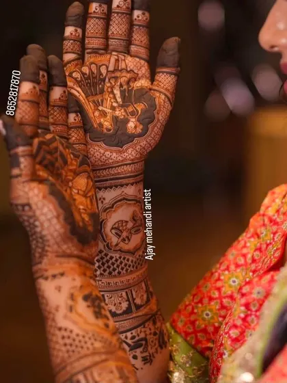 A side view of a bride's hands, showing how the portrait design on the palm connects seamlessly with the patterns on the back of the hand and arm.