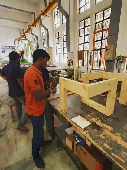 Students collaborate on the final assembly of their project, a crucial phase where all their planning and precise cutting come together.