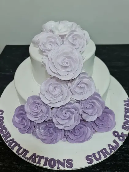 A lovely two-tier congratulations cake with a cascading waterfall of purple ombre roses. This is a beautiful choice for an engagement or anniversary celebration.