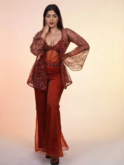 A full-length shot of the rust-colored corset set, showing how all the pieces come together to create a stunning, modern desi look.