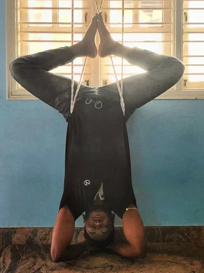 A supported headstand variation using the ropes. This allows me to work on alignment and stay in the pose longer, focusing on the breath without straining my neck or shoulders.