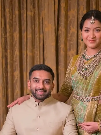 A lovely portrait of the happy couple. The mom-to-be is glowing in her green Kanchivaram saree and custom embroidered blouse, perfectly complemented by her husband's elegant bandhgala.