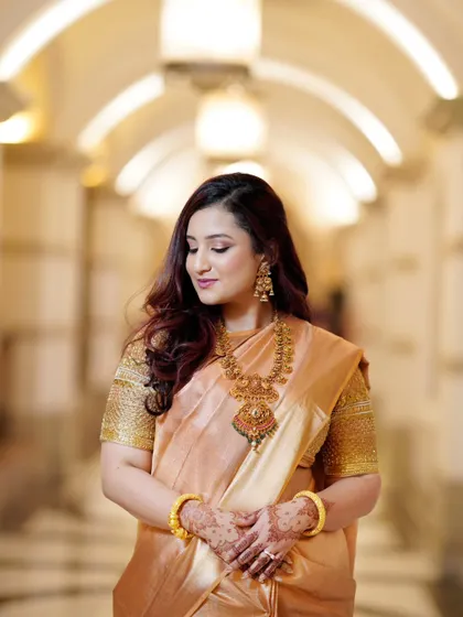 A serene portrait of the bride with her eyes gently closed. This shot captures a moment of quiet contemplation and highlights her beautiful makeup and jewelry.