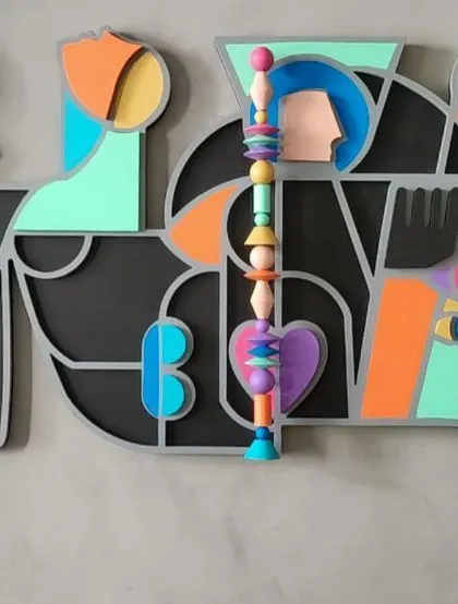 A detailed view of the 'Onwards and Upwards' piece, focusing on the central totem made of colorful Channapatna beads.